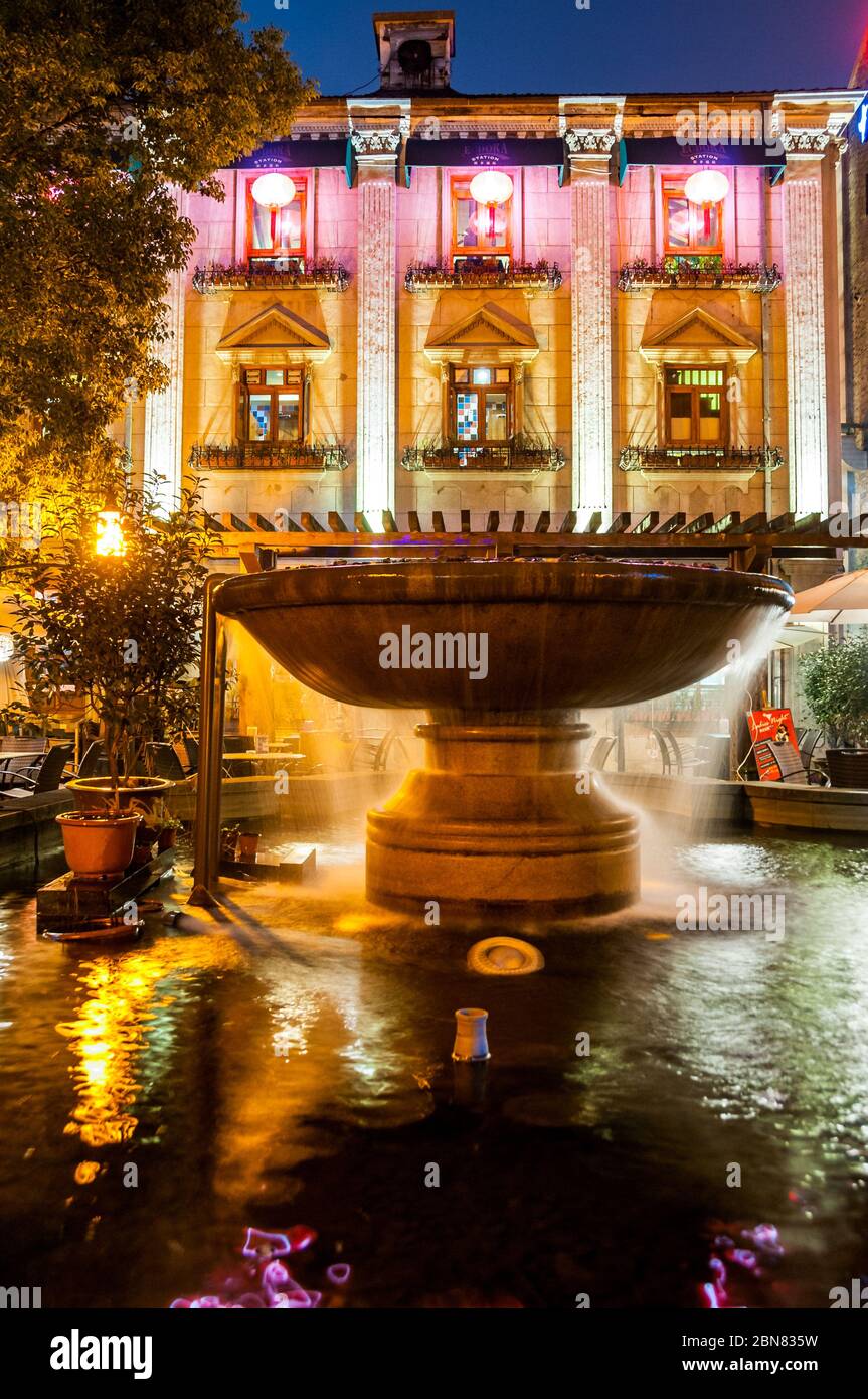 Back of Eudora Station restaurant with water fountain at night