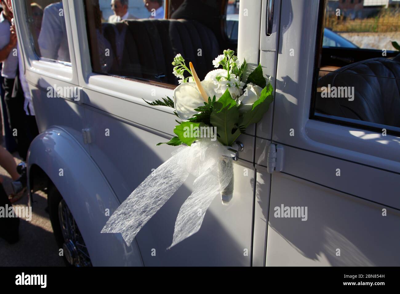 Wedding bouquet on luxury car handle Stock Photo