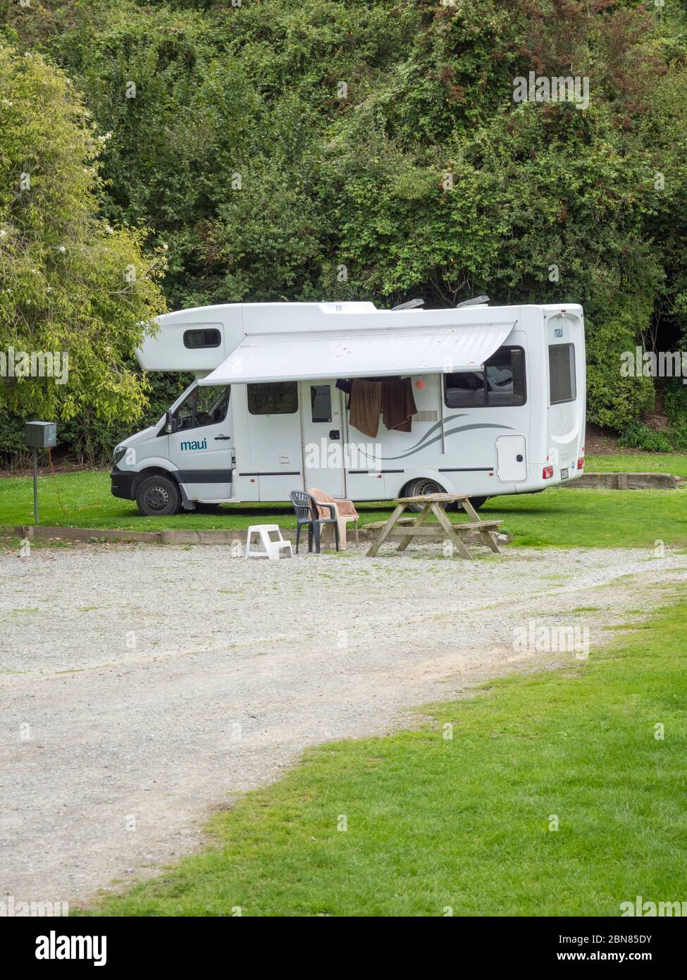 A Maui motorhome or campervan parked on a campsite in New Zealand Stock Photo