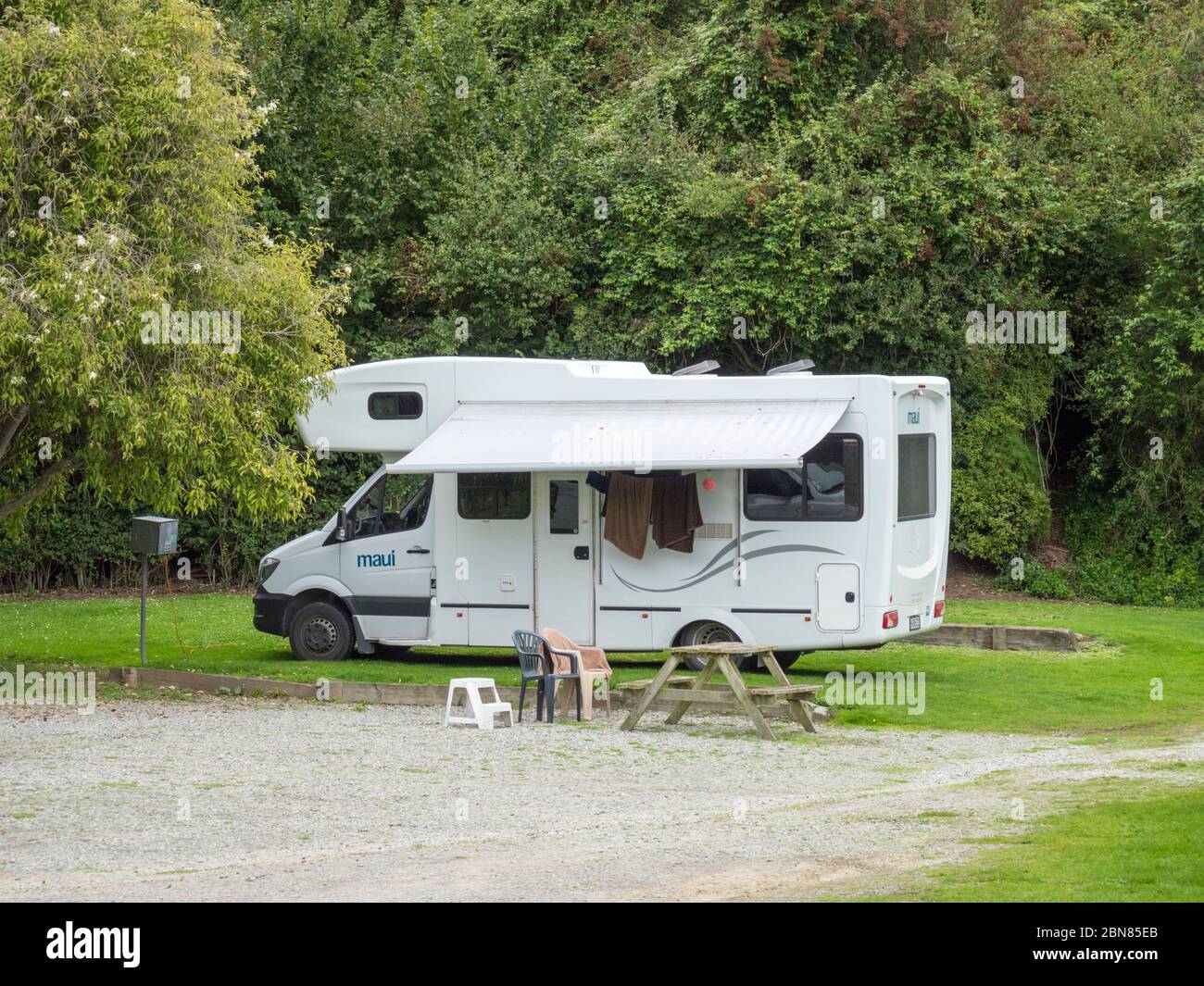 A Maui motorhome or campervan parked on a campsite in New Zealand Stock Photo