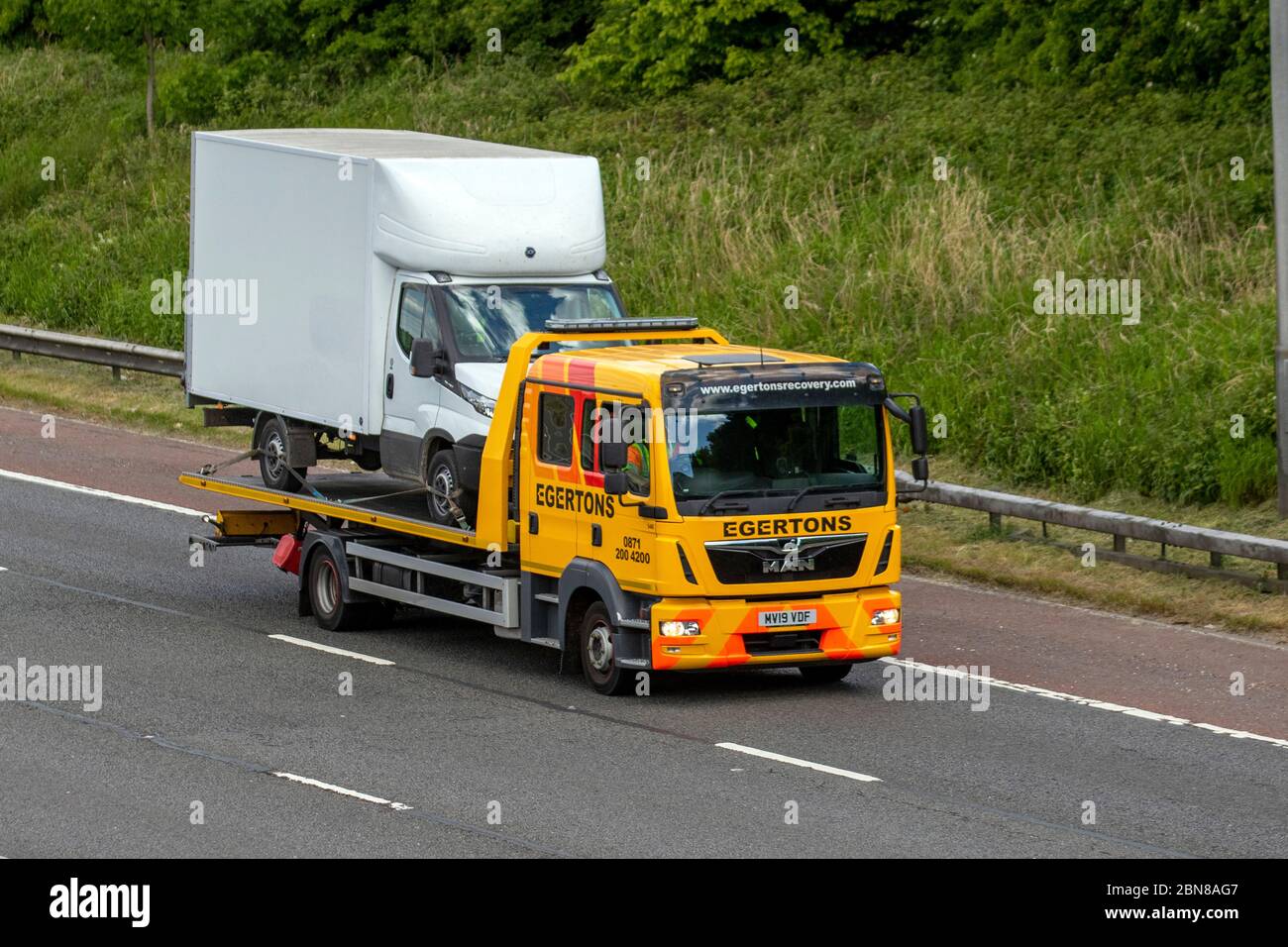 Egertons 24 hr breakdown commercial breakdown recovery service;  Haulage delivery trucks, lorry, transportation, truck, cargo carrier, Scania vehicle, European commercial transport, industry, M61 at Manchester, UK Stock Photo