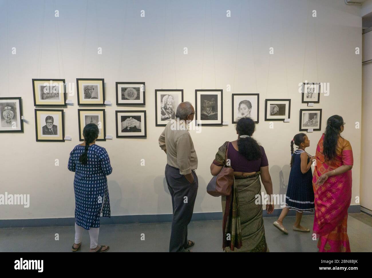People watching the paintings on display in an exhibition in Chitrakala Parishath in Bangalore (India) Stock Photo