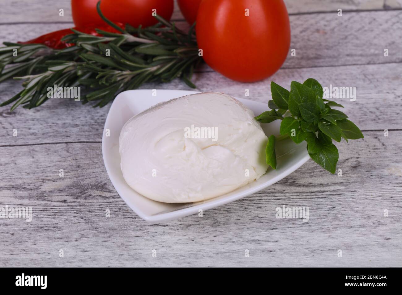 Italian Mozzarella cheese ball served basil and tomatoes Stock Photo Alamy