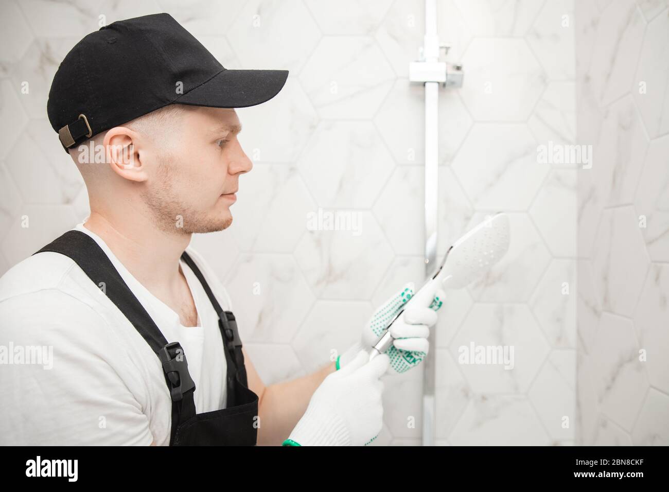 Plumber installing shower stall, work in bathroom Stock Photo Alamy