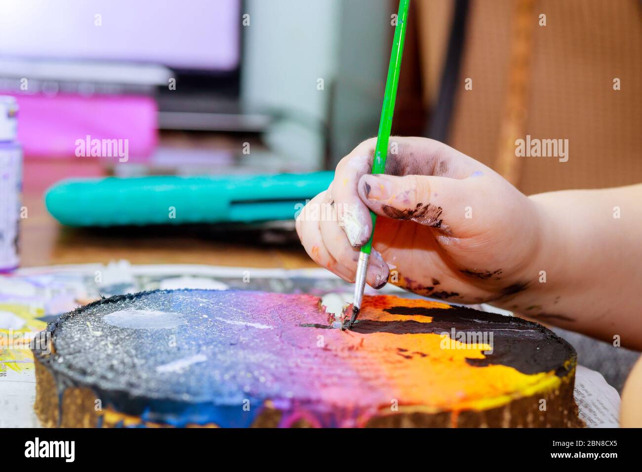 A Girl Uses In Acrylic Paint Brush To Make Her Drawings On Wooden Stock Photo Alamy