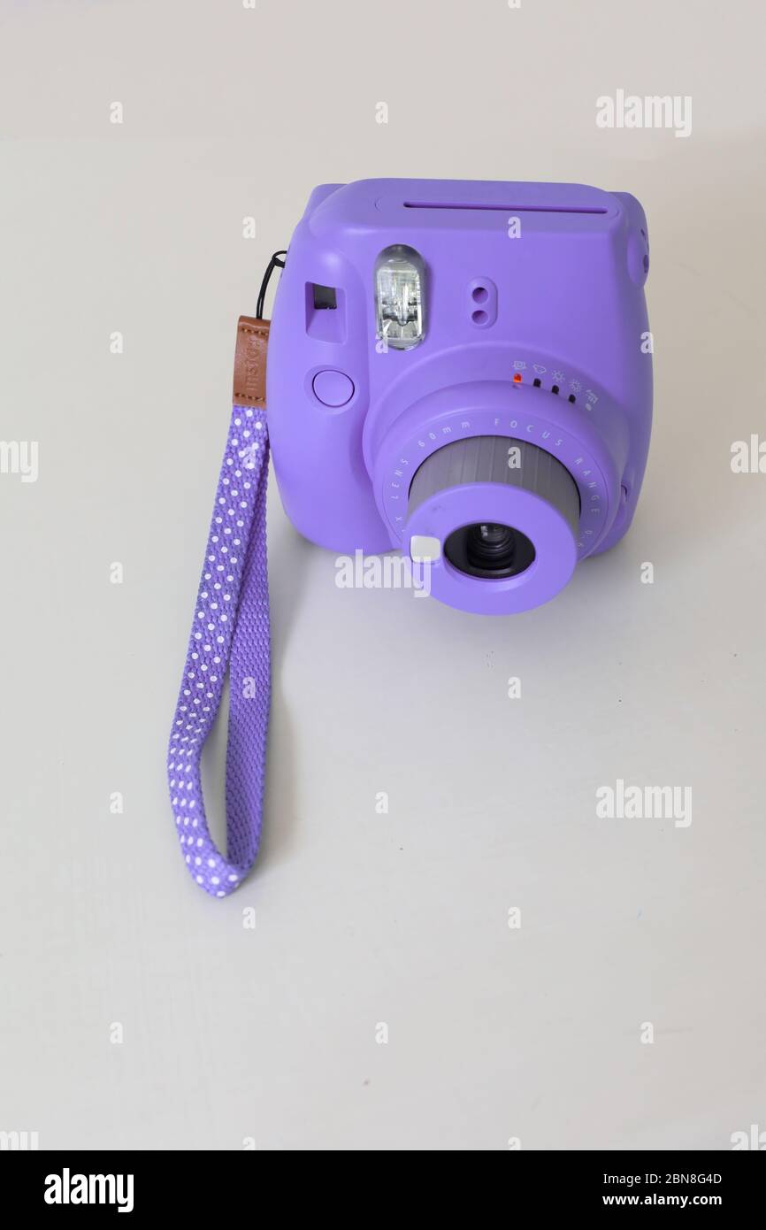 purple polaroid camera on the table Stock Photo - Alamy