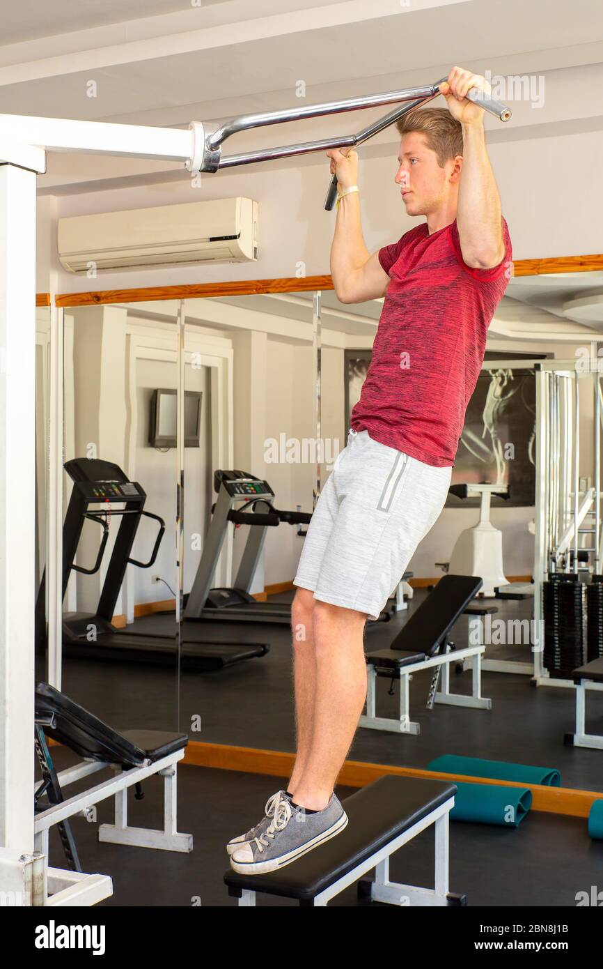 Young dutch man exercises strength training in fitness room Stock Photo