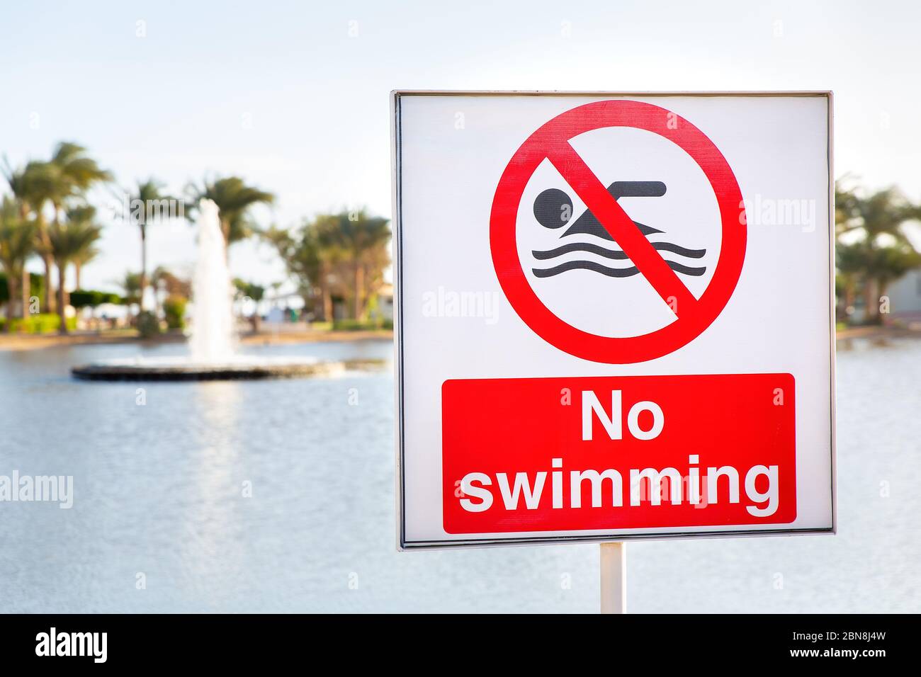 No swimming sign near water of pond in Egypt Stock Photo