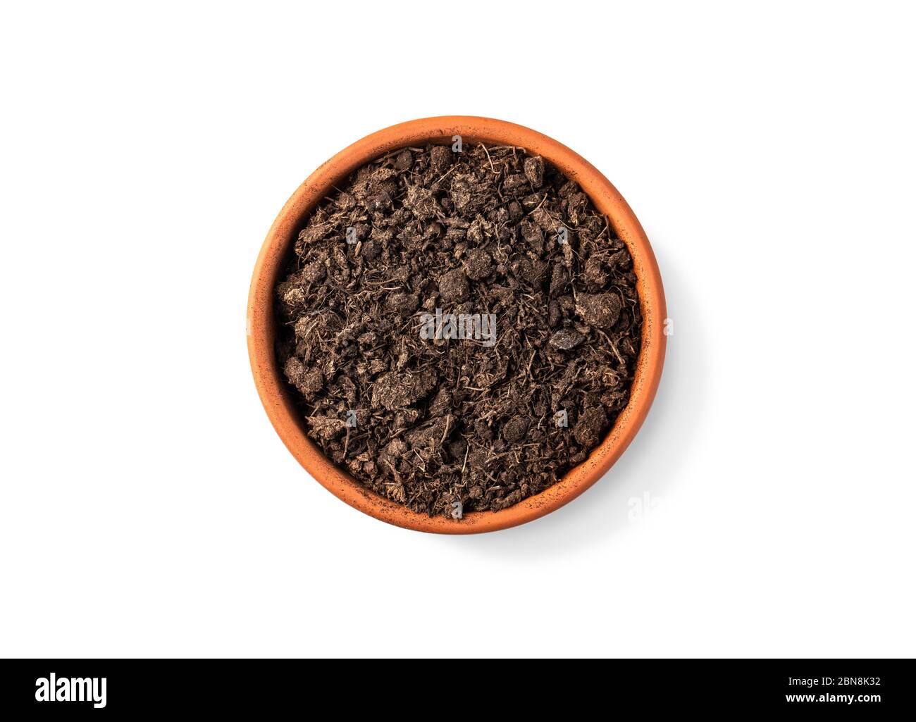 clay pot filled with organic potting soil on a white background top view with clipping path Stock Photo