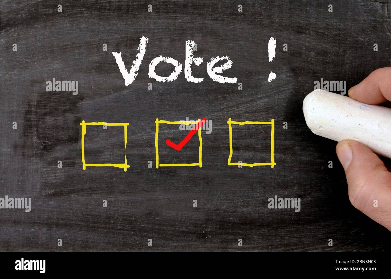 Blackboard with vote text and checkbox and hand are voting Stock Photo ...