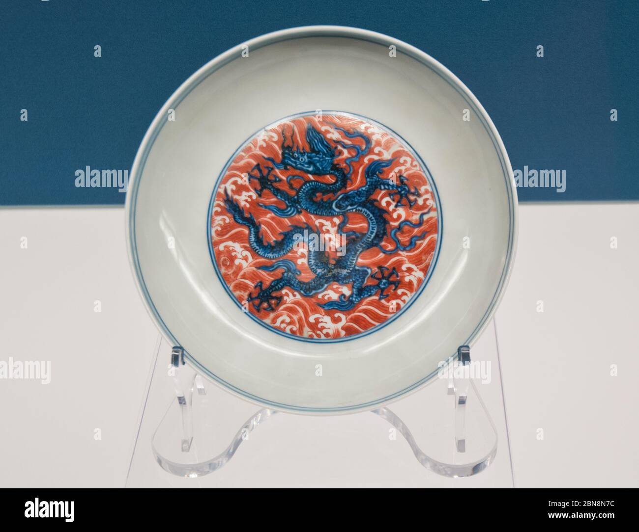 Chinese porcelain: Dish with blue-and-white dragons amid red enamel waves - Jingdezhen Porcelain Wares (mid fiftheenth Century). Shanghai Museum Stock Photo