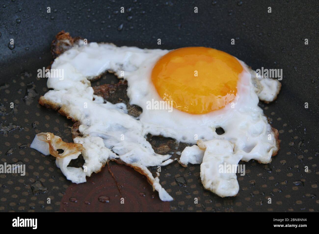 Fried egg in a pan. Over easy egg. Well done fried eggs Stock Photo Alamy