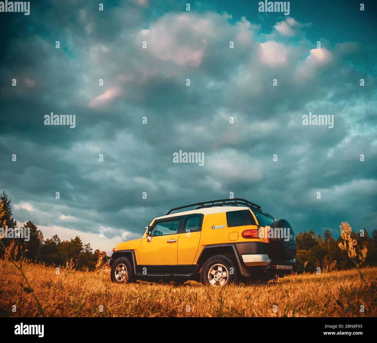 Minsk region Belarus -August 10, 2014: Yellow toyota fj cruiser xtreme car on a natural landscape background. Stock Photo