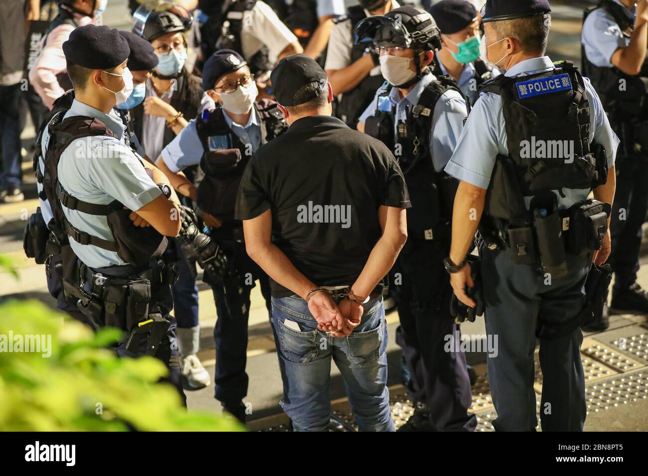 A protester being arrested and handcuffed by the police during the protest.Pro-democracy protesters gather in different shopping malls on 13 May 2020, the day of Hong Kong chief executive Carrie Lam birthday. They demand investigation for the brutality actions carried out to the protesters by the Hong Kong police during last year's protests triggered by the extradition bill. Stock Photo