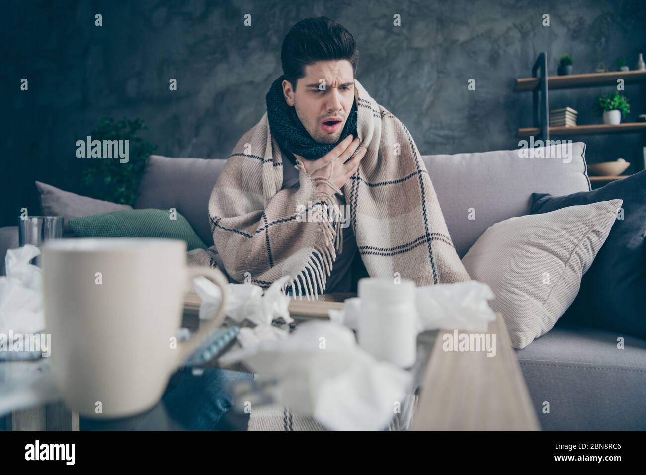 Portrait of his he sick weak guy suffering disease virus catch cold rhinitis sitting on divan