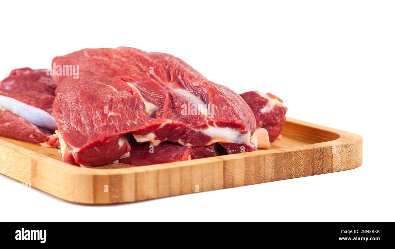 Raw meat on wooden board isolated on white background Stock Photo - Alamy