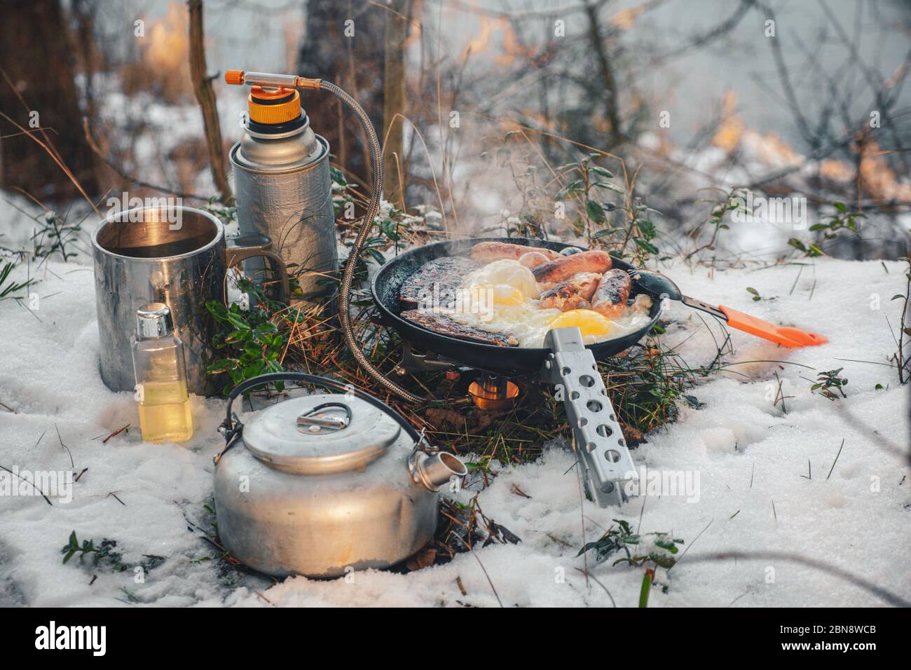 Cooking while hiking with a backpack. Stock Photo