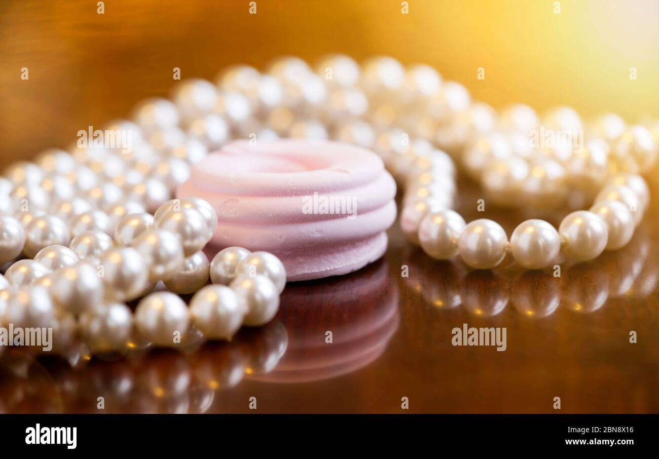 Christmas gift jewelry for women - beautiful white vintage pearls with pink candy Stock Photo