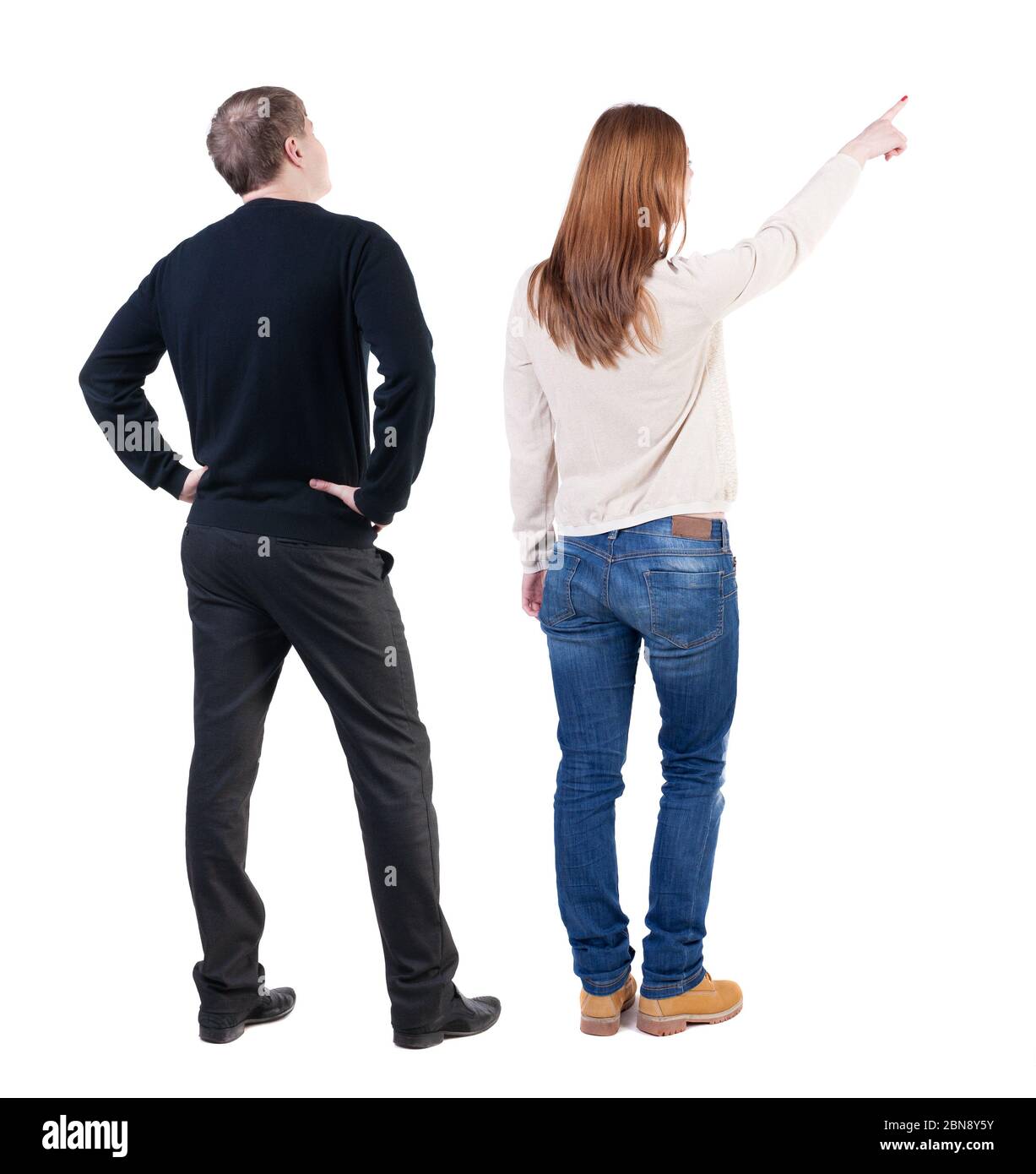 Back view of couple in sweater pointing. Rear view people collection ...