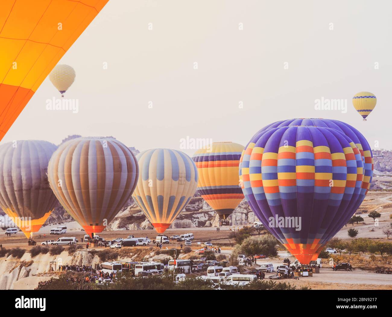 Selective focus on hot air balloons flying over the valley at ...