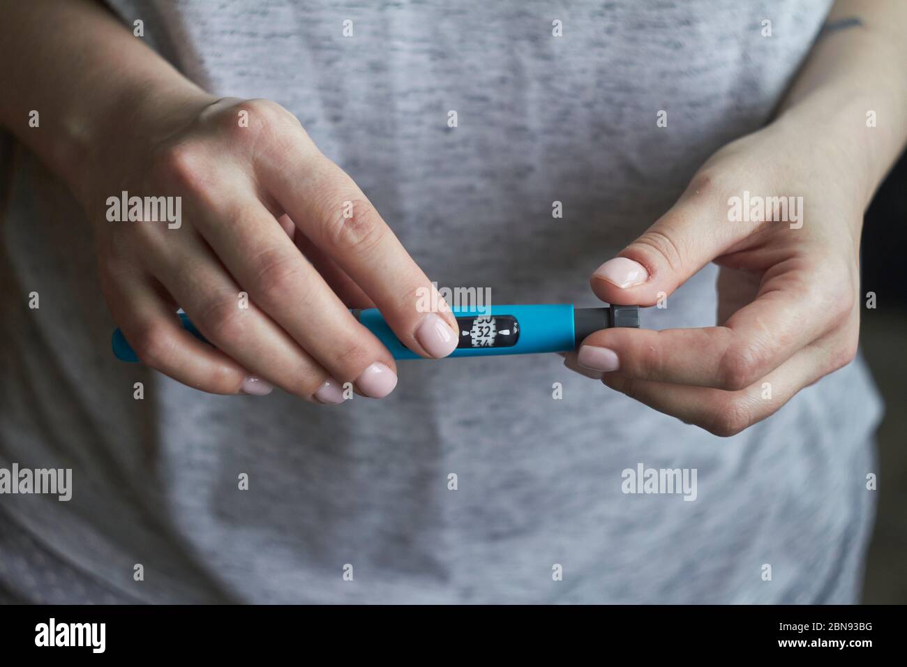 Diabetes patient turn knob on end of insulin pen and dial up correct