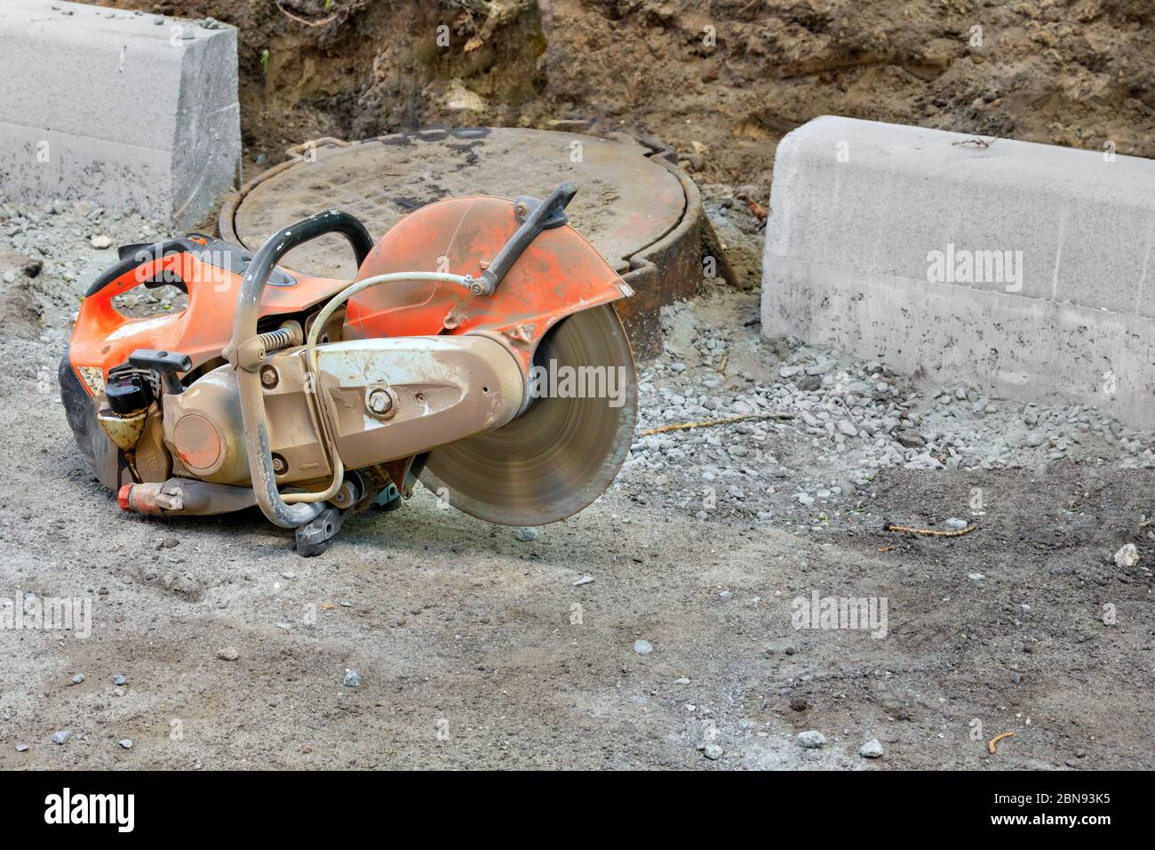 Concrete cutter at a construction site with a running engine and a