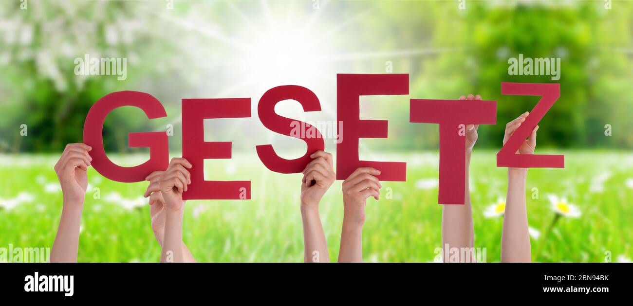 People Hands Holding Word Gesetz Means Law, Grass Meadow Stock Photo