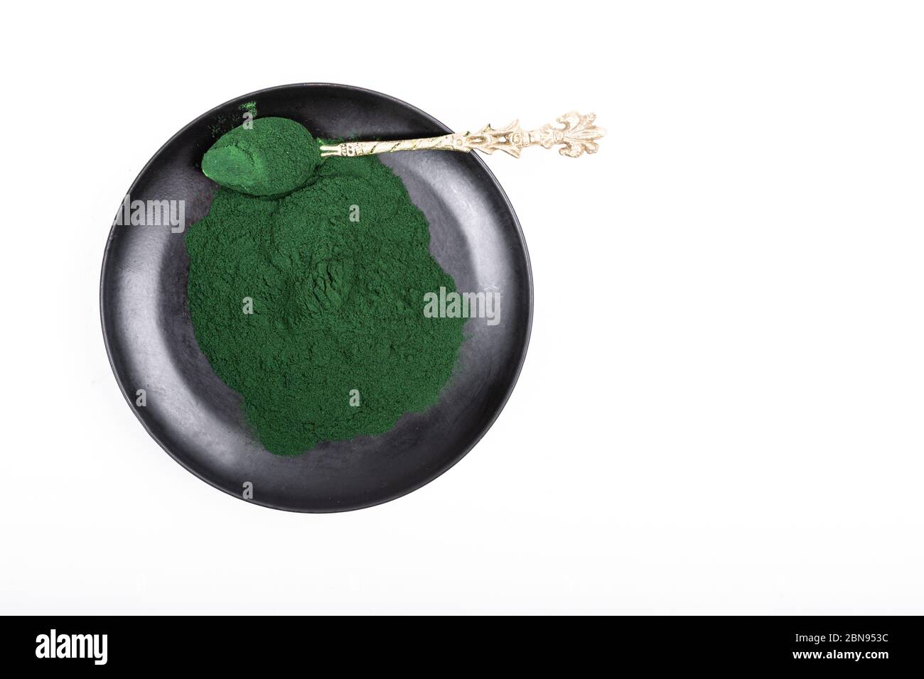 An isolated tablespoon of dried organic spirulina algae powder, on ...