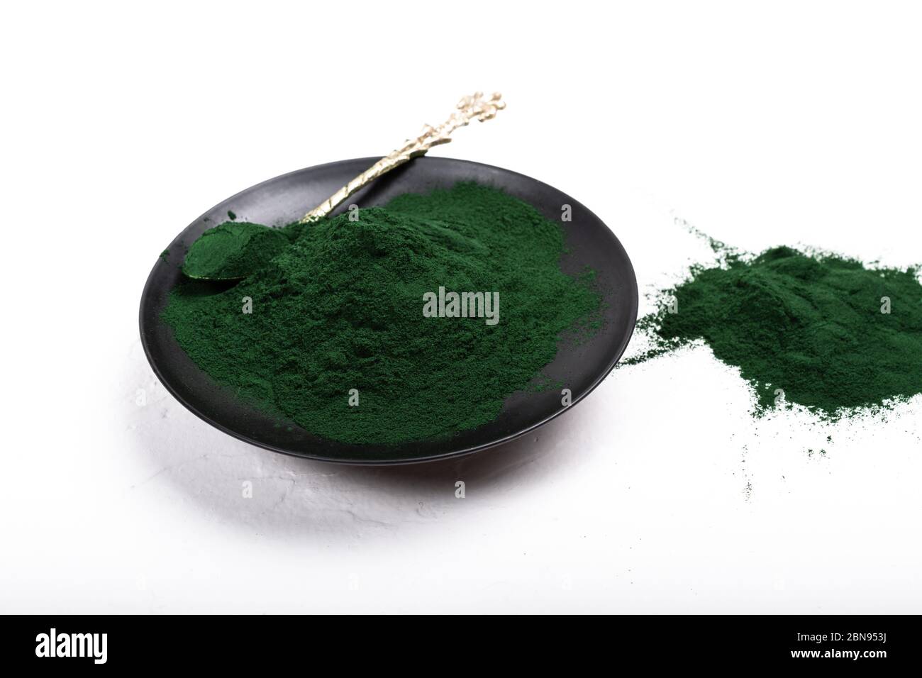 An isolated tablespoon of dried organic spirulina algae powder, on ...