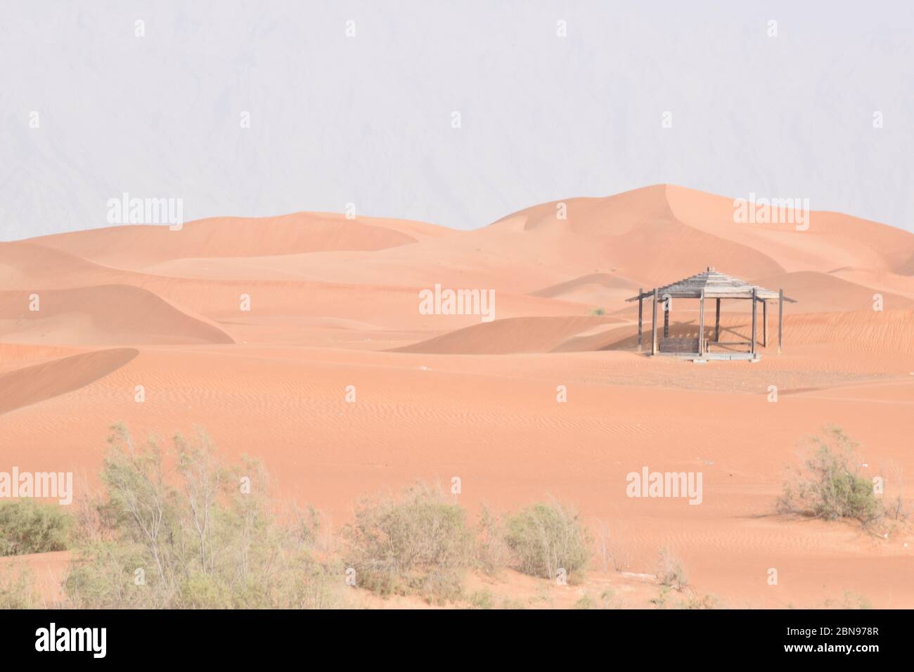 A Hut In A Red Sand Desert Near Mountains Stock Photo Alamy