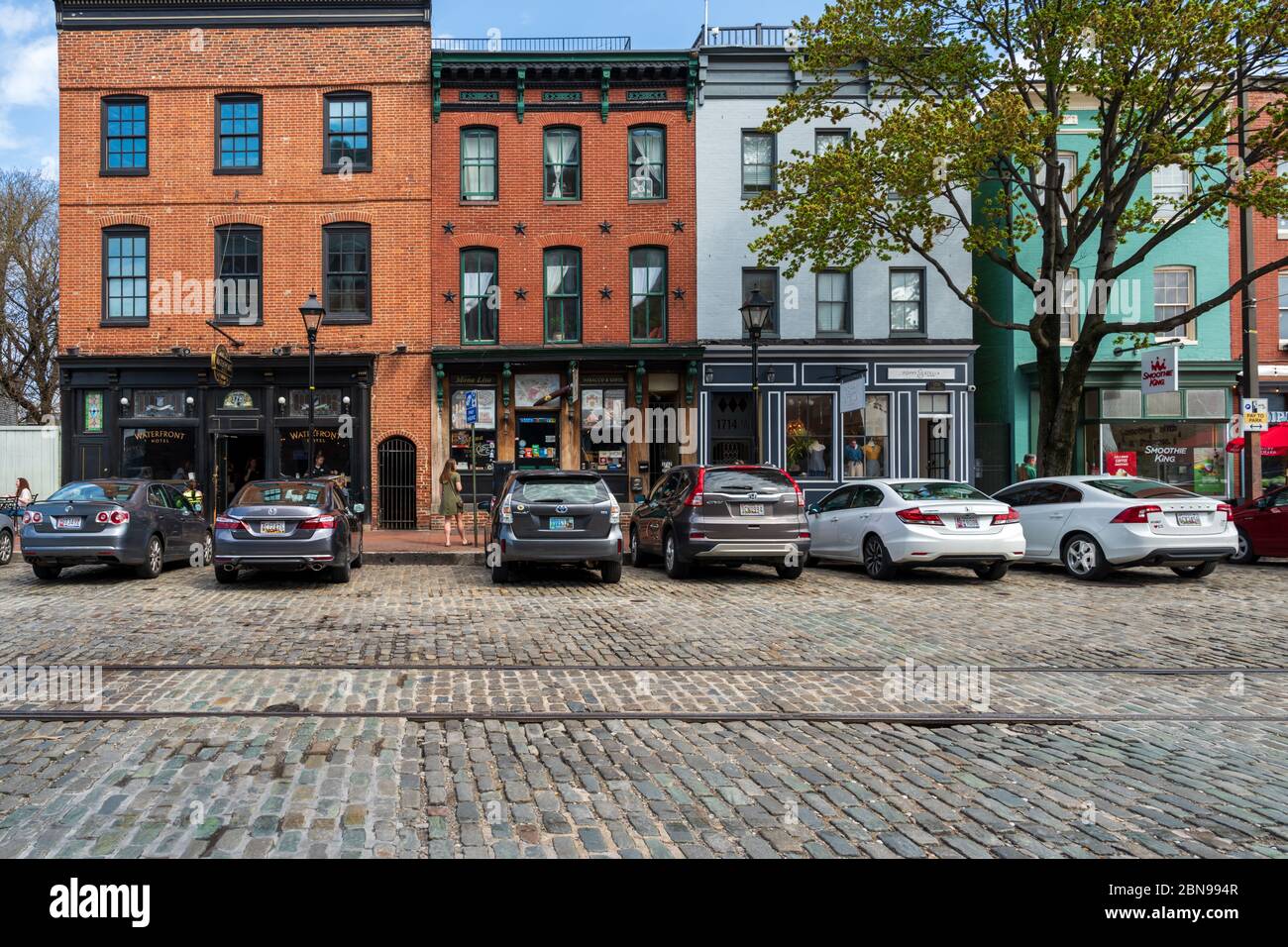 Thames St, Baltimore, Maryland, USA -- April 13, 2019. Wide angle photo of shops on Thames Street in the popular Fells Point Section of Baltimore. Stock Photo