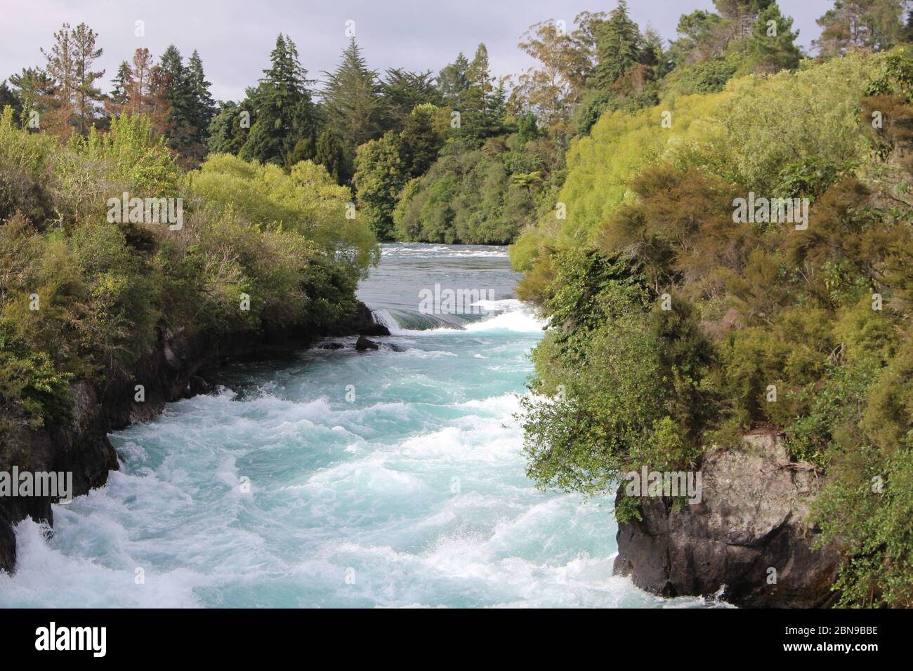 Stunning Huka Falls of Waikato River in Taupo District in Waikato Region on the North Island in New Zealand. The massive, powerfull waterfall is surro Stock Photo