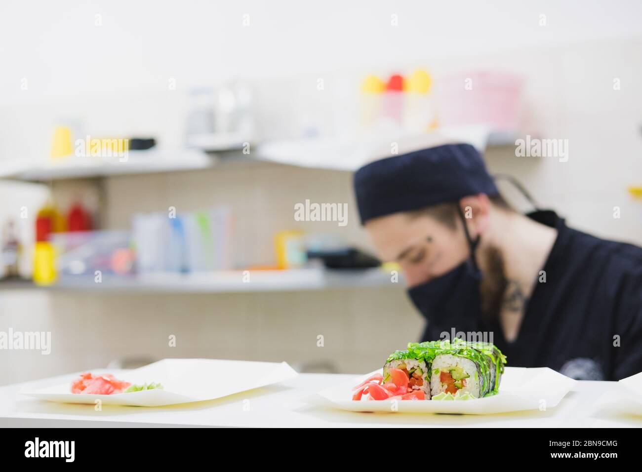 Vegan sushi rolls in the commercial take away food kitchen. Fast food, meals with delivery preparation, professional occupation and business image Stock Photo