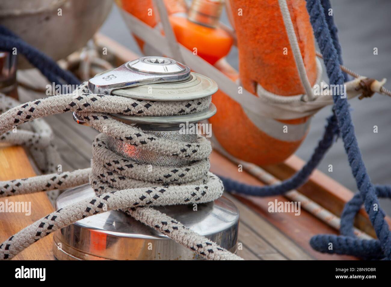 Sailboat winch and rope yacht detail. Nautical part of a yacht with cords, rigging, sail, mast, anchor, knots, lifebuoy Stock Photo