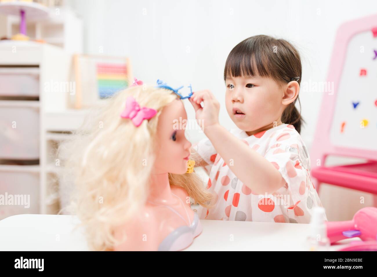 toddler girl pretend play as hairdresser at home Stock Photo - Alamy