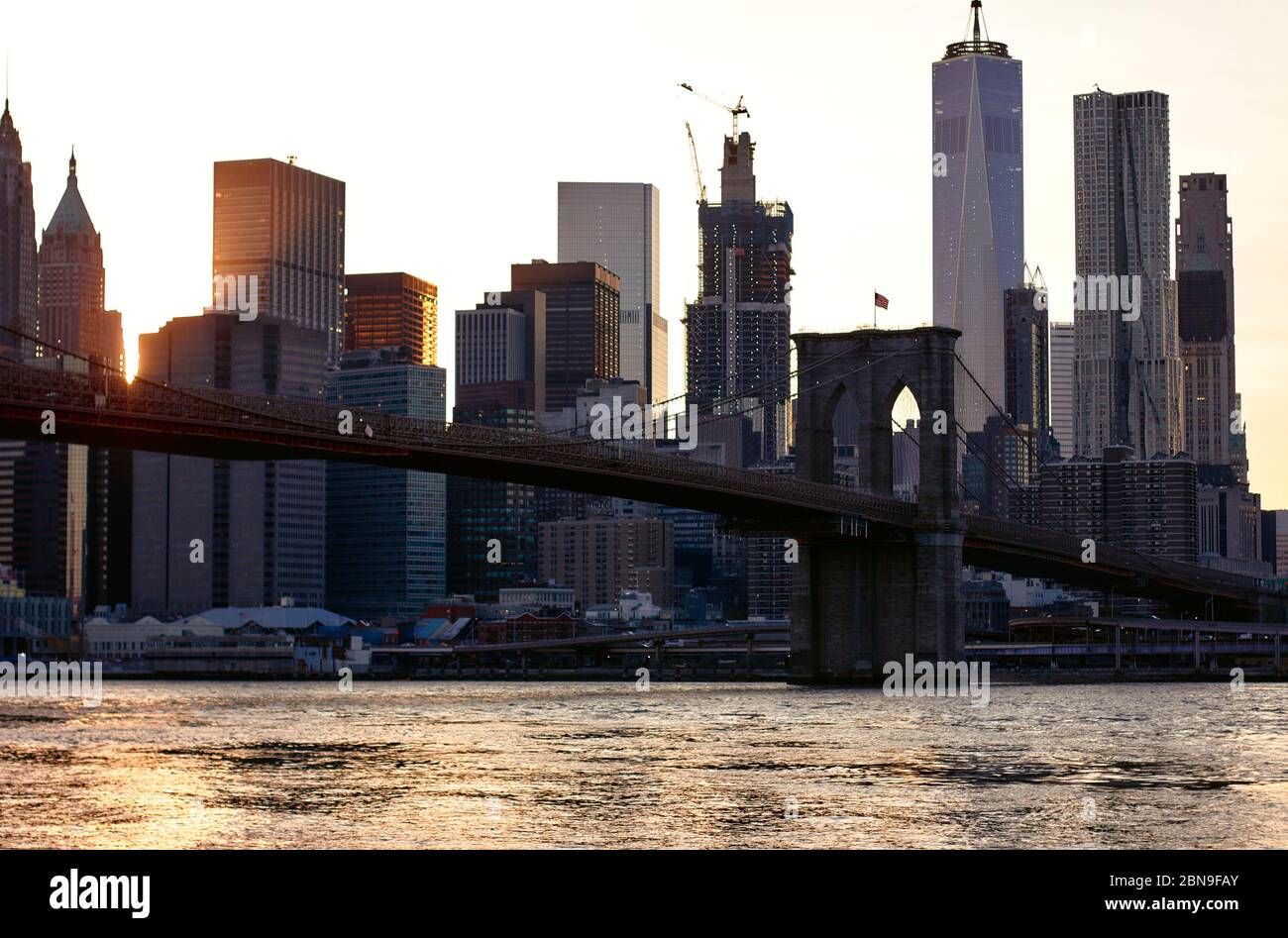 Brooklyn bridge in New York on bright summer day. Sun set Stock Photo