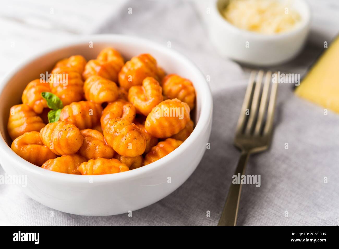 Gnocchi with tomato sauce, basil, and cheese, traditional Italian pasta food. Stock Photo