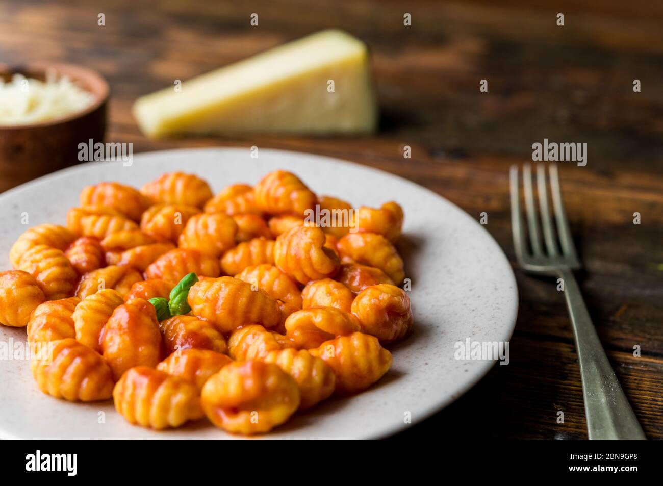 Gnocchi with tomato sauce, basil, and cheese, traditional Italian pasta food. Stock Photo