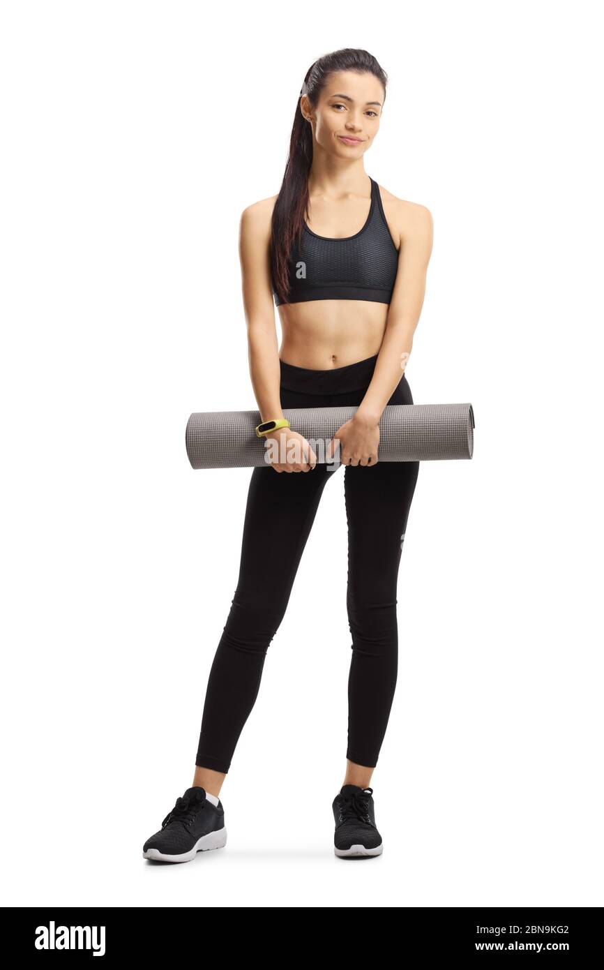 Full length portrait of a young female in sport clothes holding an ...