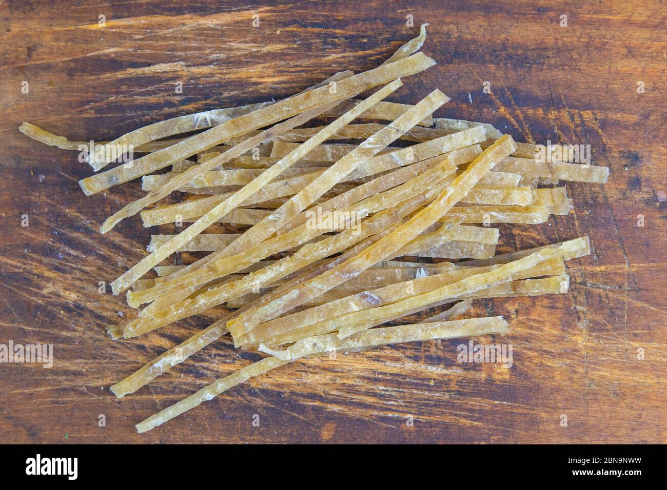 Dried salted tuna elite snack on wooden background. Snack Fish to beer. Close up Stock Photo