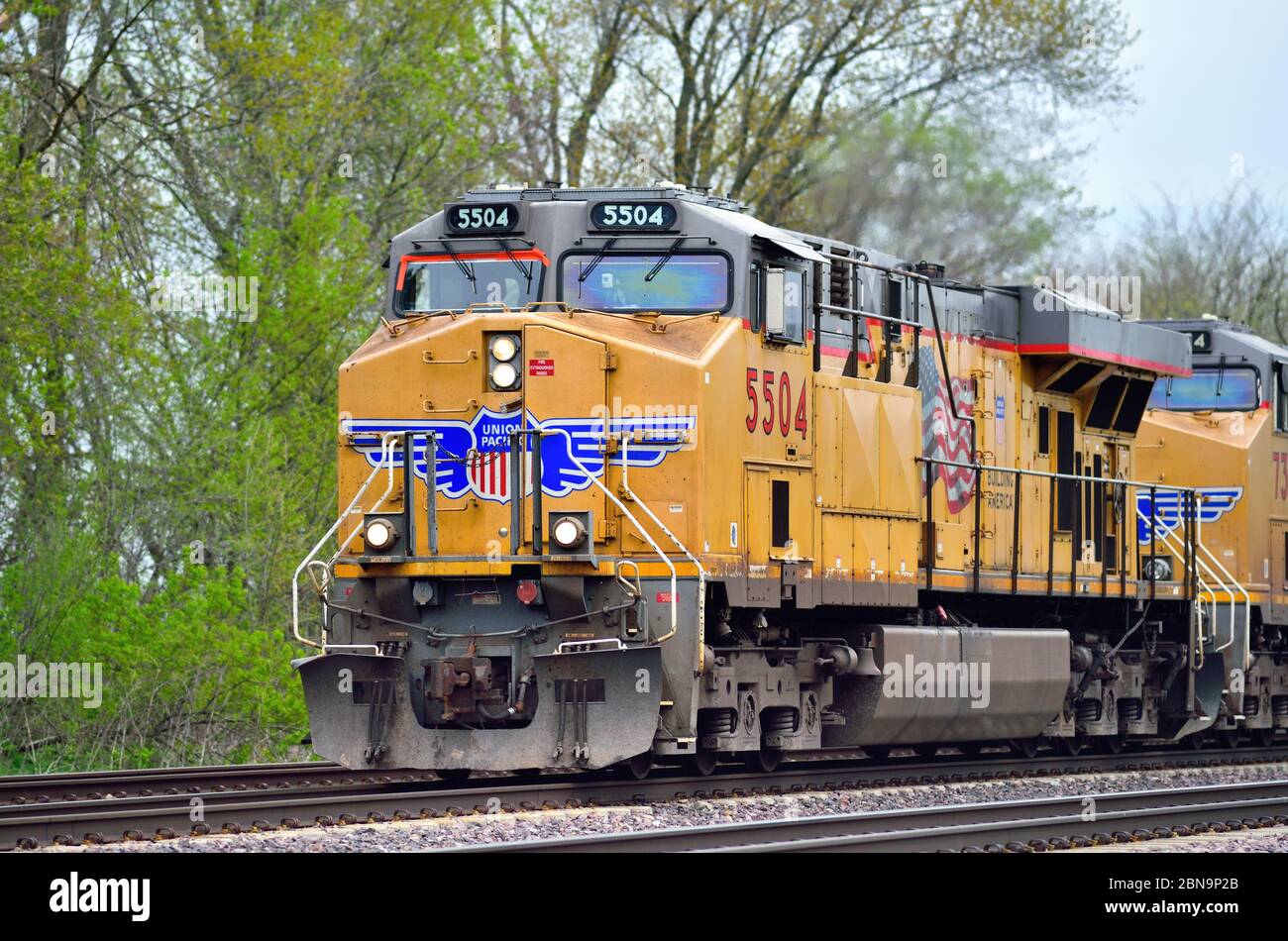 La Fox, Illinois, USA. Locomotives lead a freight train through LaFox, Illinois on its westward journey from Chicago. Stock Photo
