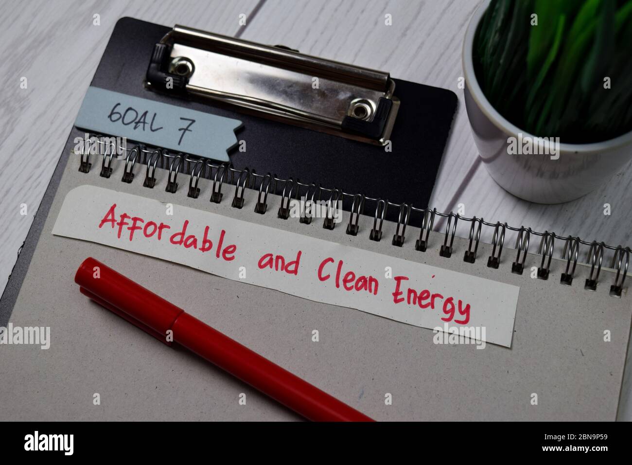 Goal 7 - Affordable and Clean Energy write on sticky notes isolated on office desk Stock Photo