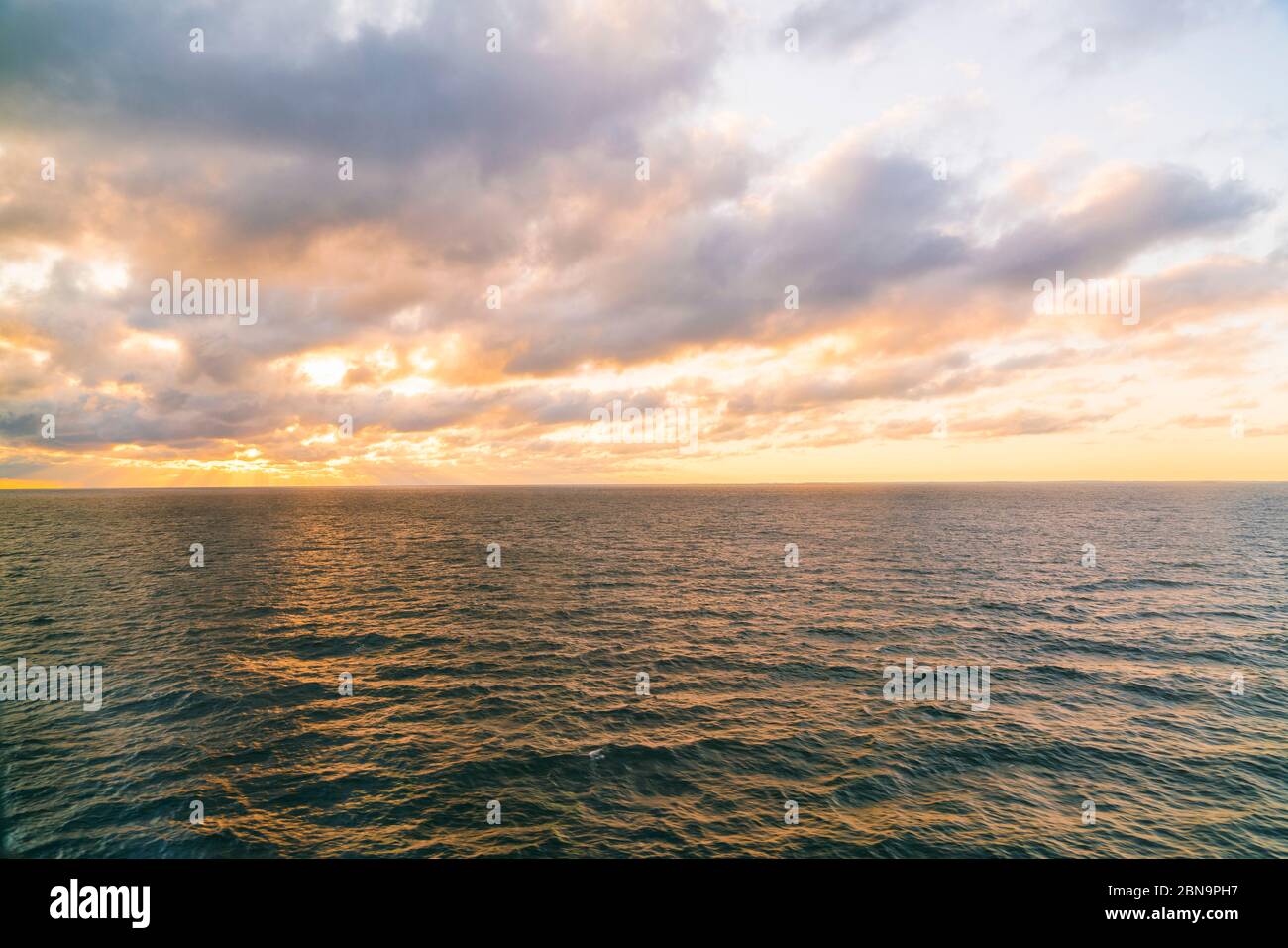 Baltic sea at the bay of finland with sun setting on the horizon Stock Photo