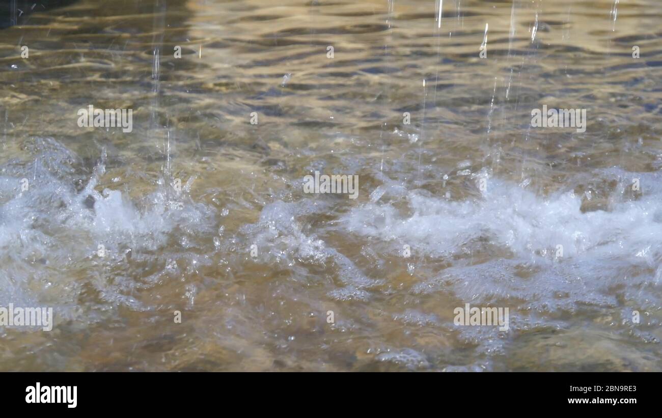 Close up view of water falling down background in day light. Stock Photo