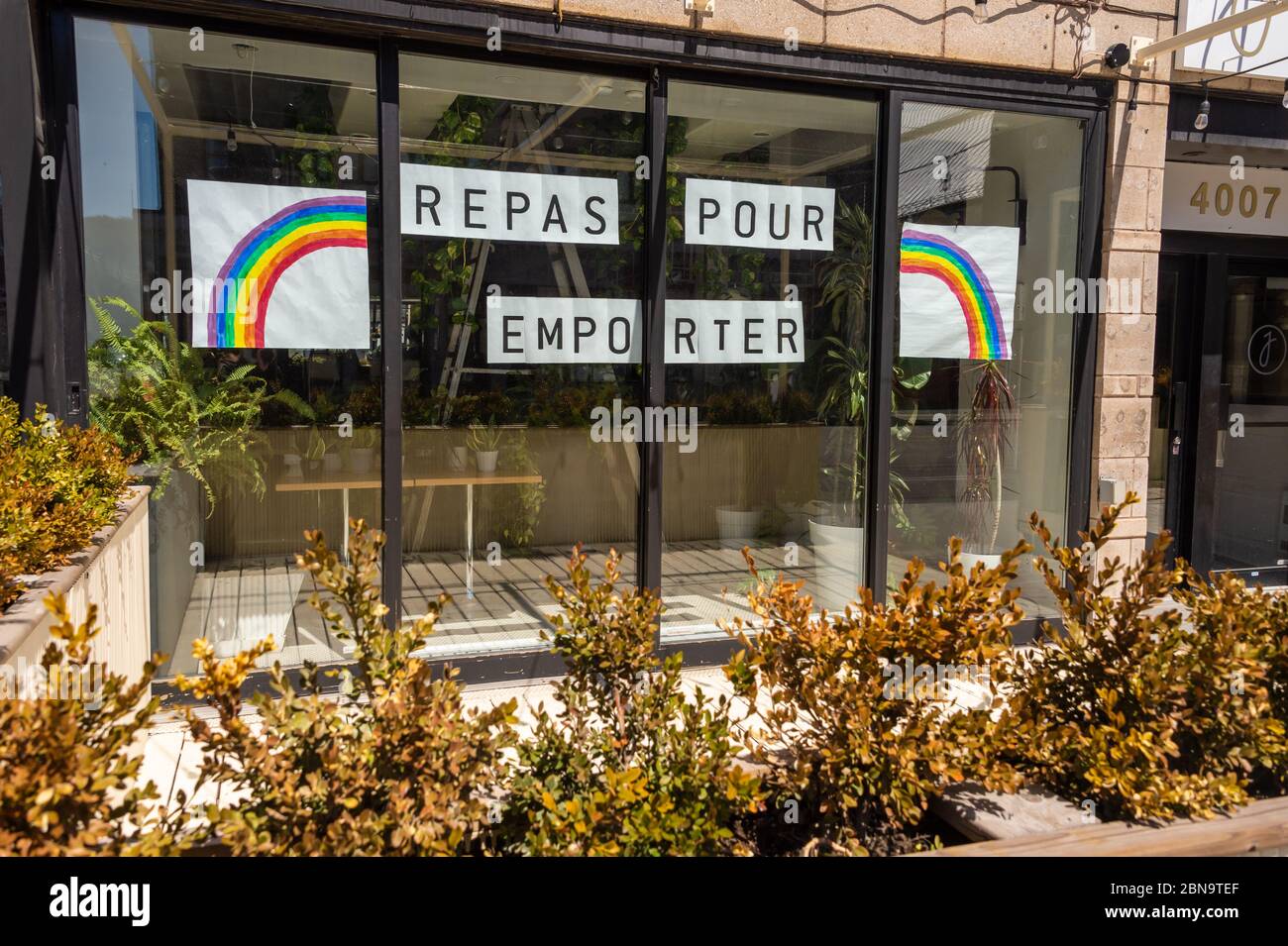 Repas pour emporter sign (Food for take out in french) posted on the window of a restaurant on Saint-Denis street during the coronavirus COVID-19 pand Stock Photo