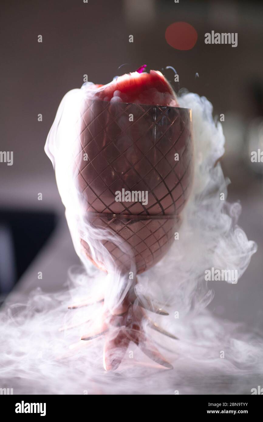 A cocktail with liquid nitrogen steams and runs over Stock Photo