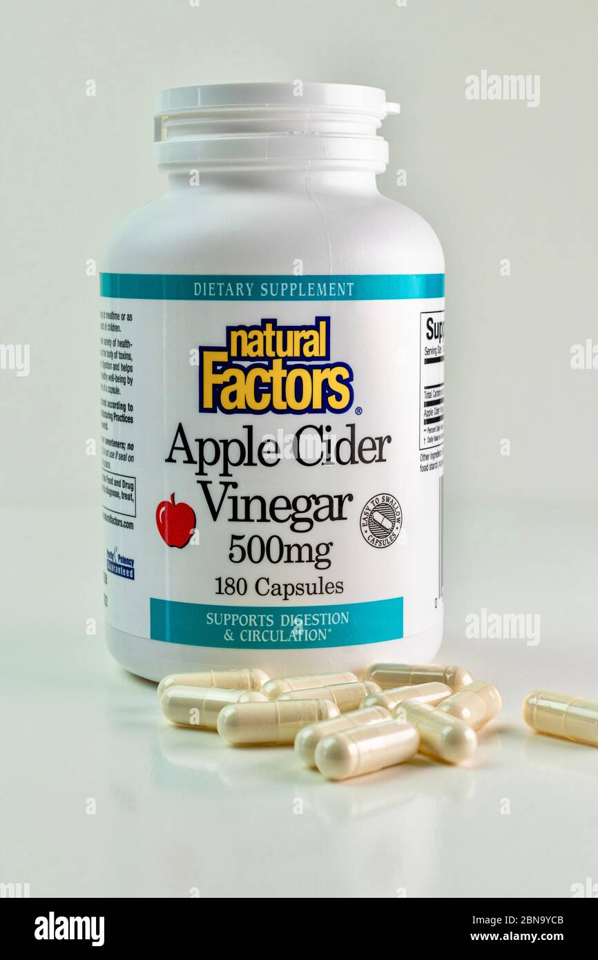 Apple Cider Vinegar Capsules and bottle isolated on white background Stock Photo