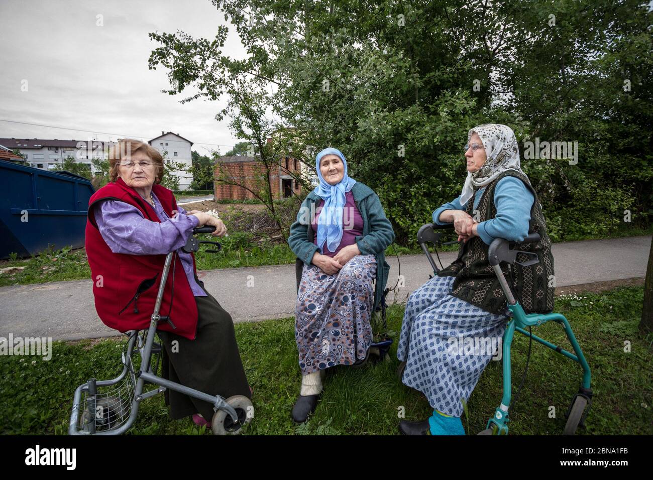 BRCKO, BOSNIA, MAY 6, 2017: Senior Bosniak Women, wearing the traditional muslim scarf, sitting and discussing among friends in the streets of the Bos Stock Photo