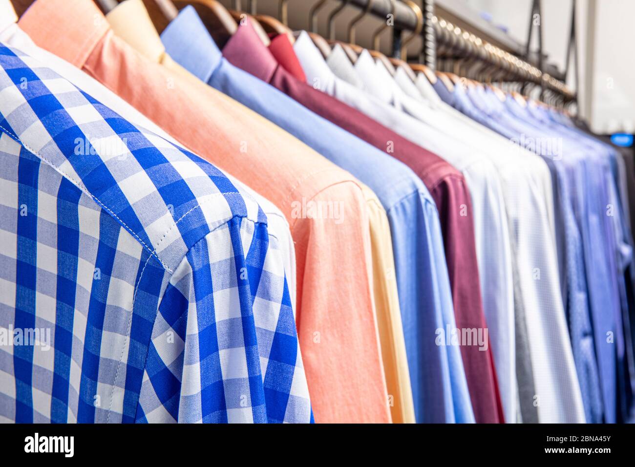 collection of shirts on hangers, men s fashion Stock Photo - Alamy