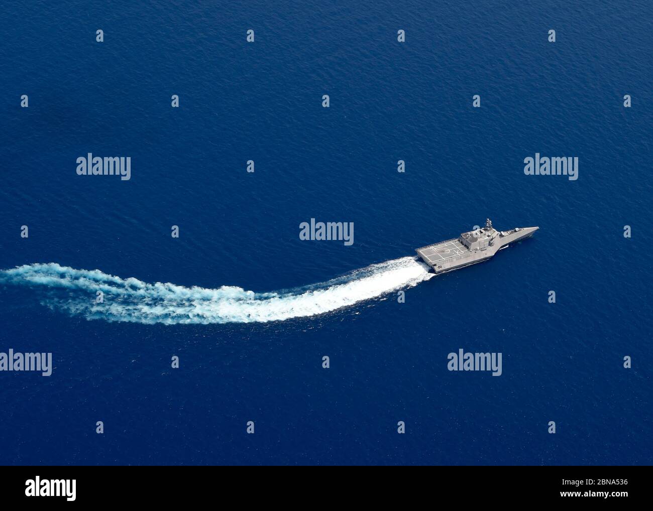The U.S. Navy Independence-variant littoral combat ship USS Gabrielle Giffords patrols near the Panamanian flagged drill ship, West Capella which has been harassed by Chinese forces for drilling in disputed waters May 12, 2020 in the South China Sea. Stock Photo